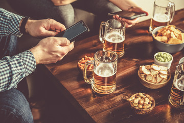 Young people at a beer party using mobile phones , wifi party toned,