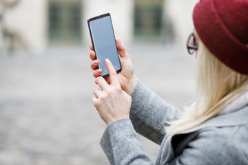 Beautiful girl using smart phone in the city.
