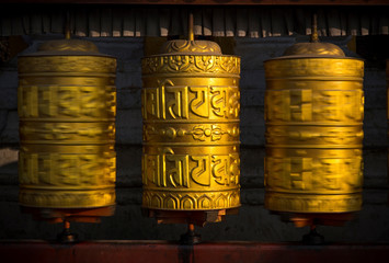 Rotating buddhist prayer wheels as symbol of buddhism religion