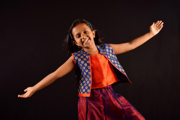 Little Girl in Indian attire with cute smile and outstretched arms posing in front of camera. Pune, Maharashtra