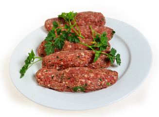Raw lamb kofta on a plate