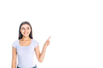 portrait of smiling young woman pointing away isolated on white