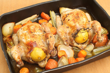 Chickens roasted on a bed of veg