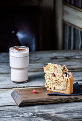 Coffe and homemade cake with nuts and fruits on dark wood background, recipe. Right view.