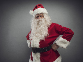 Cool confident Santa posing with arms akimbo