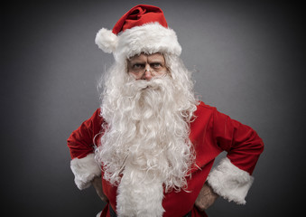 Cool confident Santa posing with arms akimbo