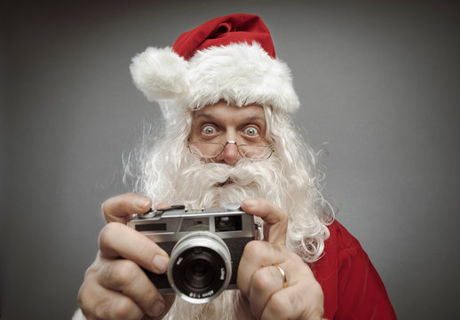 Santa Claus taking holiday pictures