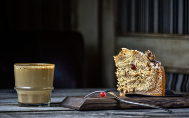 Coffe and homemade cake with nuts and fruits on dark wood background, recipe. Right view.