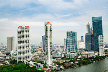 High-rise buildings with the Chao Phraya River and green spaces in Bangkok,Thailand.