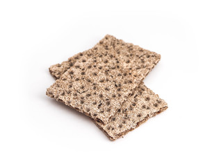 A pile of two crunchy wheat rye brown crackers, isolated on white background. Healthy food concept.