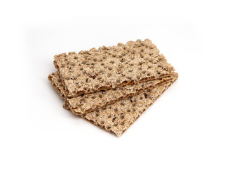 A pile of three crunchy wheat rye brown crackers, isolated on white background. Healthy food concept.