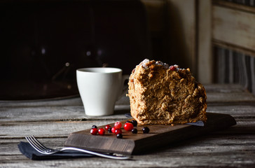 Coffe and homemade cake with nuts and fruits on dark wood background, recipe. Right view.