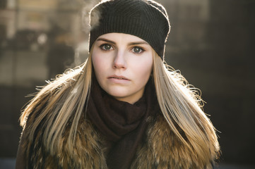 Portrait of young woman at sunny winter day.