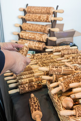 Women buying Rolling Pins with Christmas Symbols for Homemade Christmas Cookies