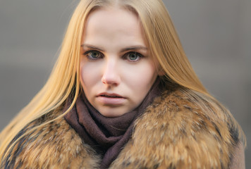 Portrait of young woman at sunny winter day.