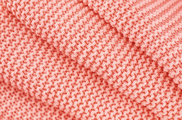 Knitted texture in Coral color. Close up.