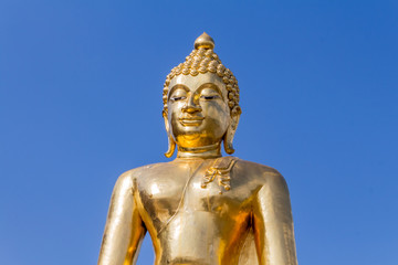 Fototapeta na wymiar Golden Buddha statue with clear sky background in Golden Triangle, Sop Ruak, Thailand