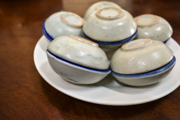 Fototapeta na wymiar Porcelain Cup of Khanom Thuai or Thai Coconut Custard, Thai Dessert.