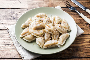Dumplings, filled with meat, ravioli. Traditional Russian dish pelmeni. Dumplings with filling horizontal