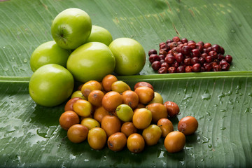 Fruit : Close up of  Different Varieties of Indian Jujube Apple Isolated on Green Banana   Leaf Background Shot in Studio