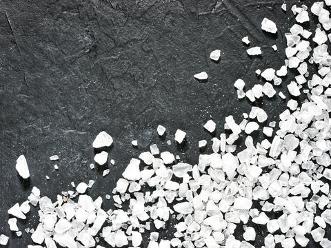 coarse sea salt on dark background close up. Copy space. Flat lay or top view