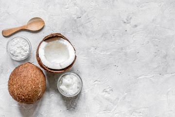 Obraz na płótnie Canvas organic cosmetics with coconut on gray background top view