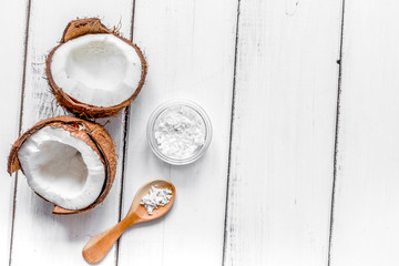 fresh coconut with cosmetic oil in jar on white background top v