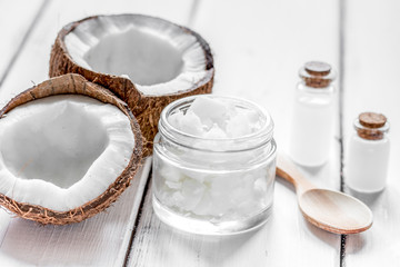 fresh coconut with cosmetic oil in jar on white background mocku