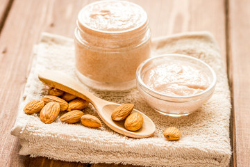 Obraz na płótnie Canvas cosmetic for women with almond scrub on desk background