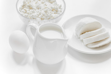 monochrome concept with dairy products on white table