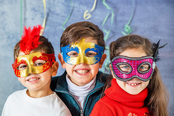Three kids celebrating Carnival  together at home