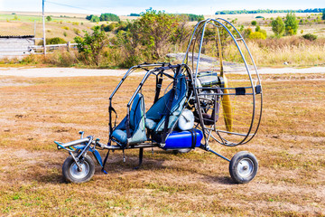 Closeup of moto paraglider on the field.