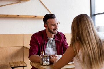 Cute couple having coffee together in cafe
