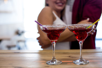 Beauty couple having fun at cafe with cocktails