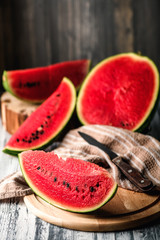 Watermelon on a rustic table. Pieces of red flesh close up