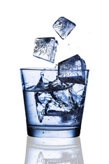 Splash ice cubes into a water glass