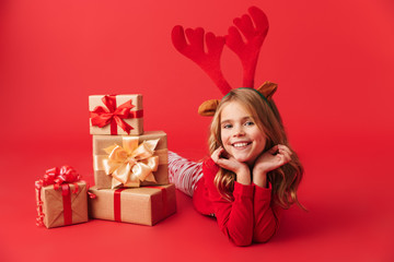 Cheerful little girl wearing Christmas raindeer costume