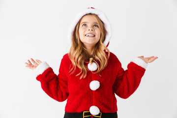 Cheerful little girl wearing Christmas costume sitting