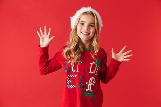 Cheerful little girl wearing Christmas costume