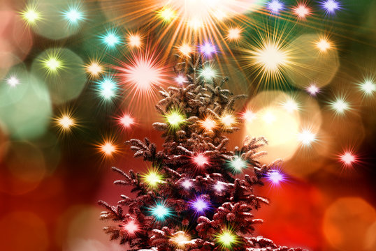 image of Christmas tree on colorful lights background