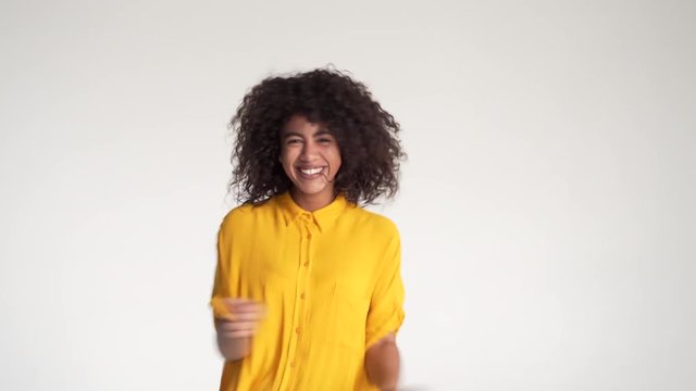 African american woman dancing on white background