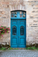 Old vintage rustic wooden doors painted in blue.