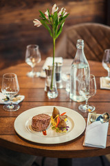delicious beef steak with sauce and vegetable, served on white plate, modern gastronomy, michelin restaurant