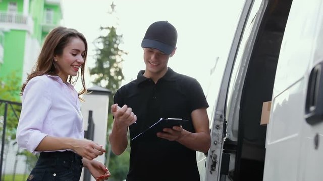 Delivery Courier Service. Man Delivering Package To Woman