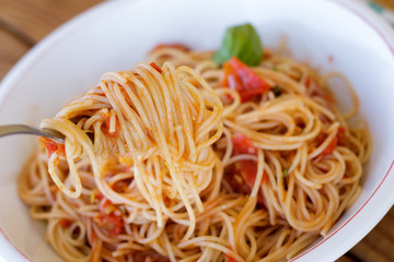 Eating spaghetti napolitain with selective focus