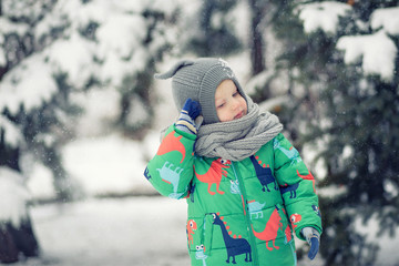 Funny baby and snowy winter