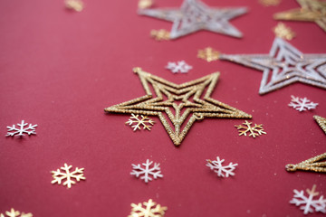 Fototapeta na wymiar Stars and snowflakes on red background. Christmas concept.
