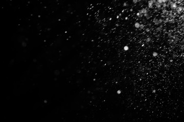 Falling snow on a black background. Snowfall weather. Texture for overlay