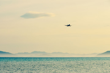 Fototapeta na wymiar small airplane silhouette against a clear pink sky