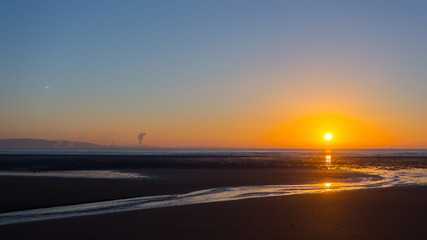 Swansea beach sunrise and distant steel works